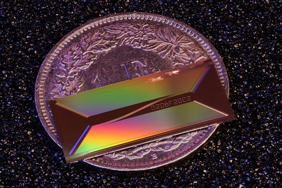 photonic chip placed on a coin