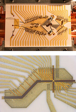 The NIST X-trap is constructed from a sandwich of two diamond-shaped alumina wafers, visible in the right center of the top photo