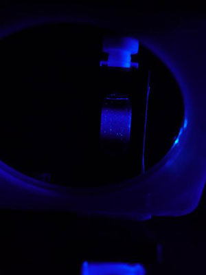 This is a suspension of nanoparticles in a quarz-glass cell exposed to ultra violet light. The nanoparticles emit deep-blue fluorescence