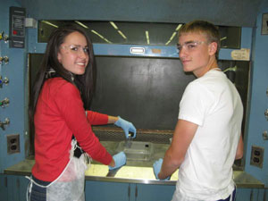 Colton-Pierrepont Central School students Kelly Sampier (left) and Mark Avery (right) prepare an experiment using arsenic and iron oxide nanoparticles