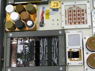 Samples of novel nanocomposite materials, seen in the photo, will be mounted to the hull of the space station