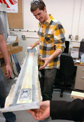 Students in a mechanical engineering design class at the University of Nevada, Reno remove from the ski press a new ski with a novel vibration dampening design