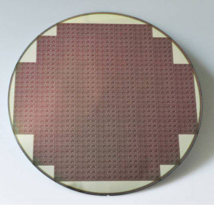 A photograph of an 8-inch (20 cm) silicon wafer fabricated with a grid of stress sensors to measure changes in residual stress during mechanical back grinding