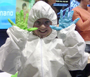 A NanoDays participant learns about nanotechnology by trying on a clean suit, like those worn by scientists