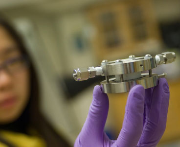 Doctoral student Yi-Chun Lu holds an experimental lithium-air battery that was used for testing at MIT