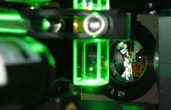 A 5-micrometer glass bead levitated in air by a single laser beam from below. This optical trap is formed by the force from the laser beam and the gravitational force on the bead