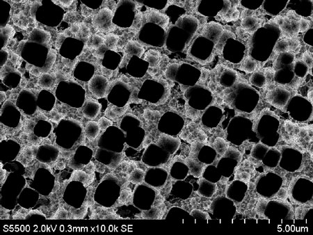 Microscopic pores dot a silicon wafer prepared for use in a lithium-ion battery