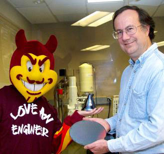 ASU materials science and engineering professor James Adams and ASU Sun Devils mascot Sparky display new materials in a university research lab