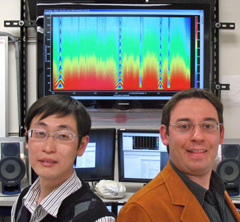 Haohua Wang (left) and Matteo Mariantoni in front of an image of SWAP spectroscopy