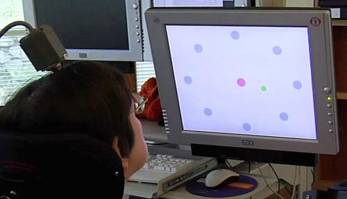 A woman with paralysis controls a computer cursor on a screen by the neural activity of intending to move it with her arm and hand