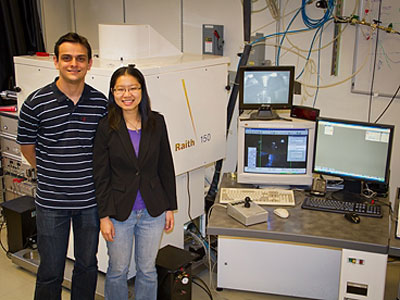 Research Laboratory of Electronics graduate students Vitor Manfrinato and Lin Lee Cheong, with the electron-beam lithography system they used in their experiments