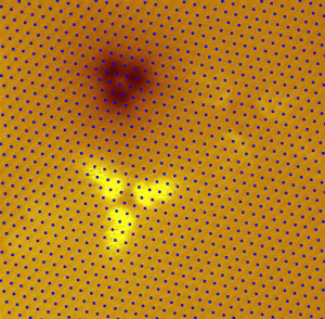 A scanning tunneling microscopy image of two defects in a thin film of the topological insulator Bi2Te3