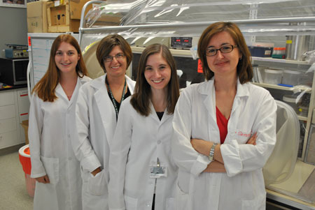 Microbiologist Gemma Reguera (right) and her team of researchers have unraveled the mystery of how microbes generate electricity while cleaning up nuclear waste.