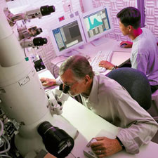 ASU School of Materials professor Ray Carpenter (at left) is pictured doing research with Ph.D. student Young-Chul Kim , using a high- resolution analytical transmission electron microscope at ASU’s J.M. Cowley Center for High Resolution Electron Microscopy