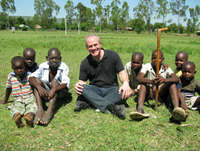 Jay Keasling with children in a village outside Nairobi, Kenya