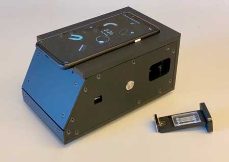 A photo of a device attached to an ordinary smartphone that can detect the presence of SARS-CoV-2 in a nasal swab