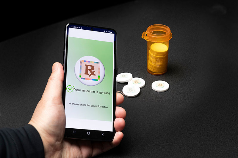 using a smartphone application to activate a cyberphysical watermark on medication