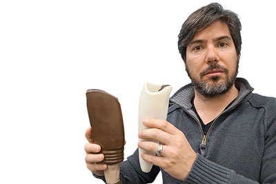 Professor Matt Ratto with a conventional prosthetic (at left) and (at right) one printed by his lab