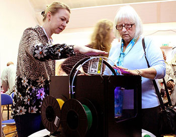 Blind and visually impaired guests, hearing and feeling the heat of the 3D printer