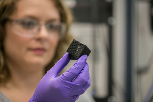 Lab researcher Jennifer Rodriguez examines a 3D printed box