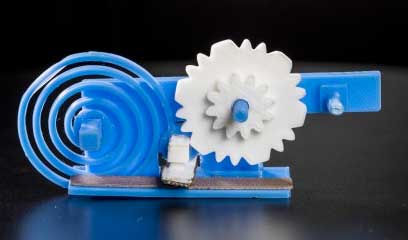 3-D printed gears (in white) and spring (blue spiral)
