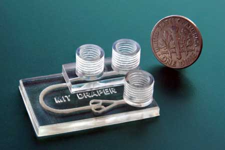 3-D printed microfluidic device in comparison to a one dime coin