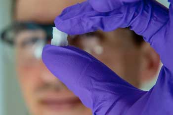 Rice University graduate student Sean Bittner holds a 3D-printed scaffold created to help heal osteochondral injuries
