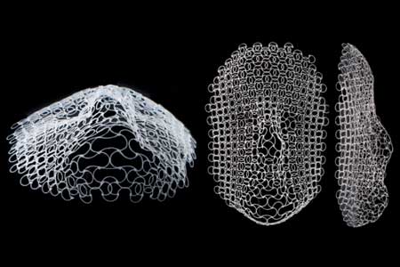 A lattice structure, originally printed flat, has morphed into the outline of a human face