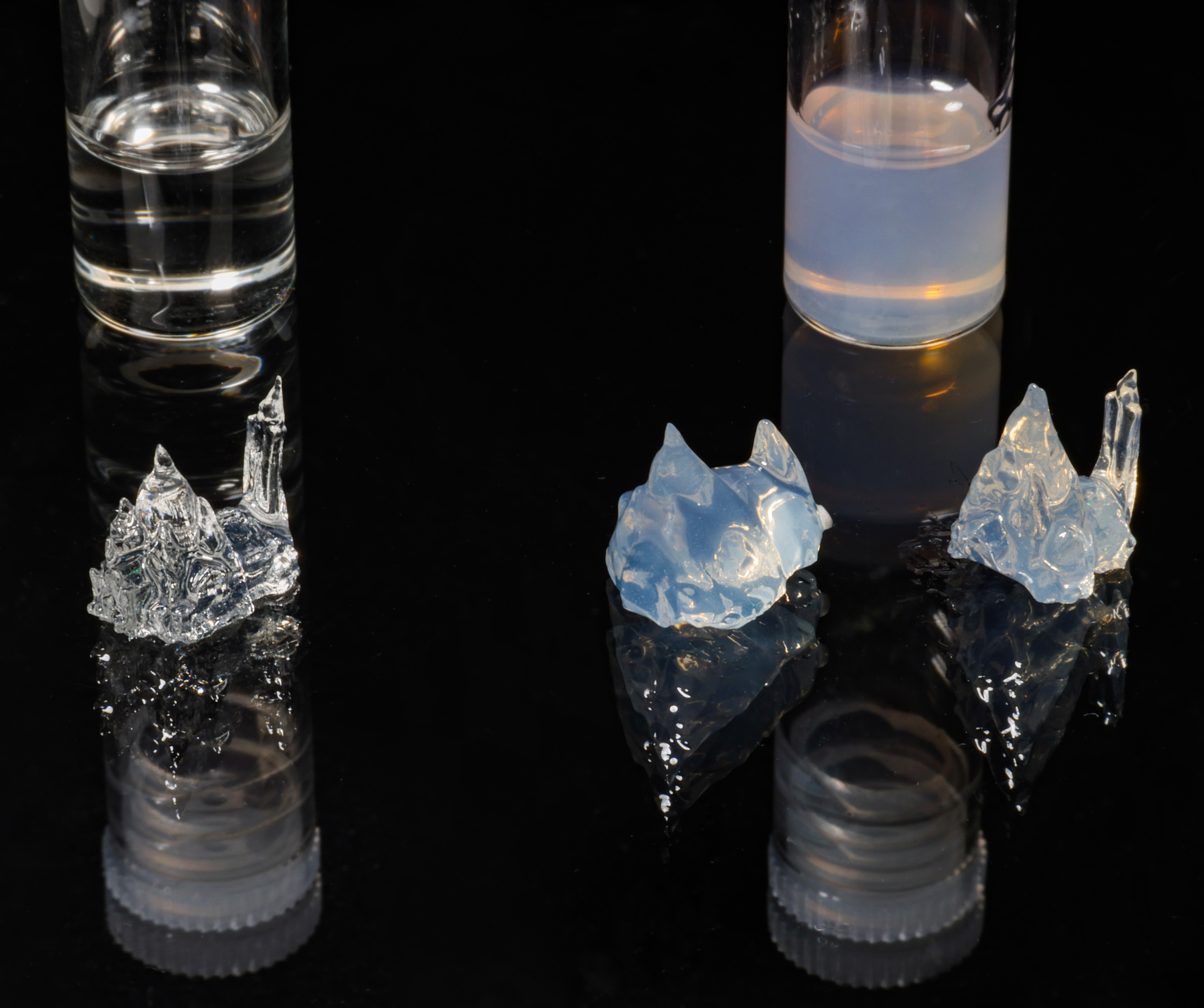 Three 3D-printed objects, one made from transparent resin (left); one from opaque resin