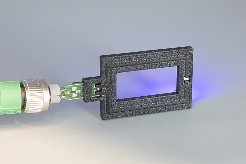 LED demonstrator with integrated circuit board, printed TPE track, contacted LED and insulating PBT housing