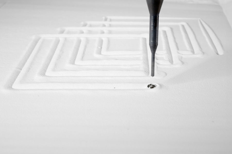 The liquid metal printing process involves depositing molten aluminum along a predefined path into a bed of tiny, glass beads