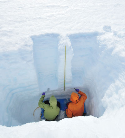 Atmospheric scientists Sarah Doherty (left) and Stephen Warren (right) taking snow samples in Greenland