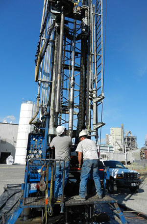 Technicians align a downhole packer and pressure/temperature monitoring system into the CO2 injection well.
