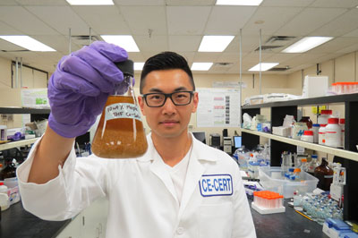 Charles Cai, a graduate student at UC Riverside, holds a mixture of maple wood and tetrahydrofuran
