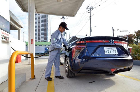 A man refuels Toyota Motor's fuel cell vehicle 