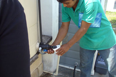 A village resident drinks purified water from the system's clean water tank