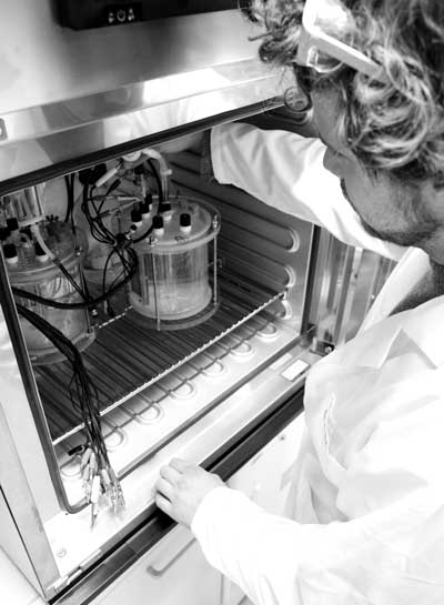 Biologist Johannes Eberhard Reiner, KIT, with the reactors for microbial electro-synthesis.