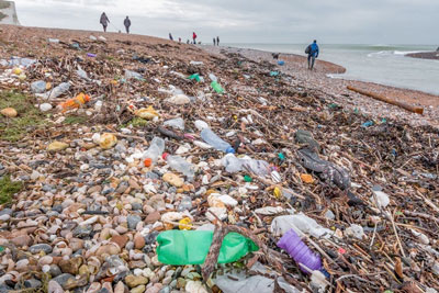 beach full of plastic garbage in Cuckmere Valley UK