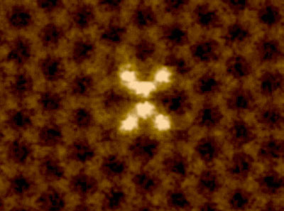 dancing motions of silicon atoms, pictured in white, in a graphene sheet