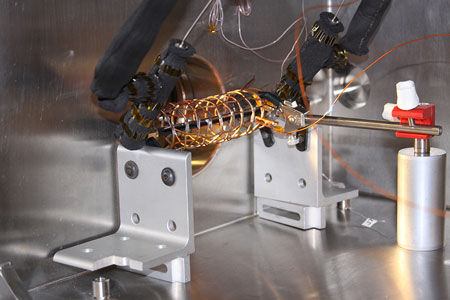 copper wire surrounding a pipe