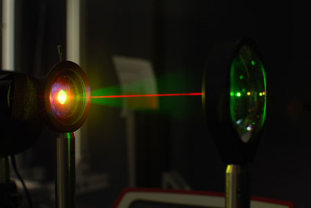A laser beam is used to test the gold-hyperdoped sample of silicon to confirm its infrared-sensitive properties