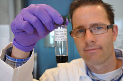 Jacob D. Lanphere, a Ph.D. student at UC Riverside, holds a sample of graphene oxide