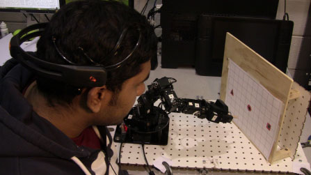 Habib Mohd Younus uses a mind-controlled robot to place a peg in a hole