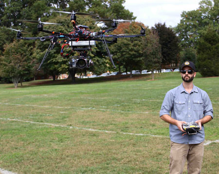 Graduate biology student Max Messinger flies a robotic drone