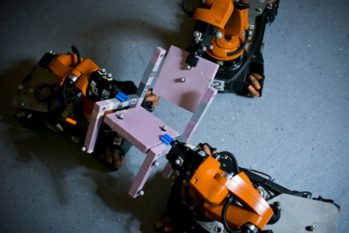 three robots assembling of a chair