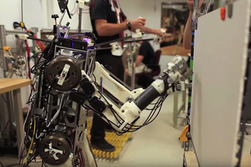 >HERMES, a bipedal robot, punches through drywall