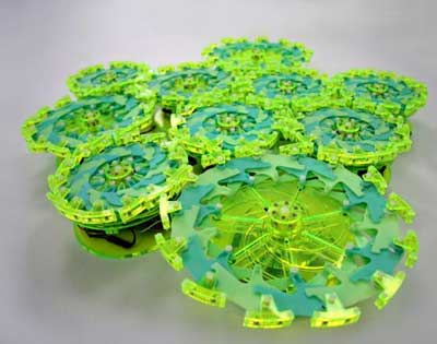 Particle robots are composed of loosely coupled components, or particles, that lack an individual identity or addressable position