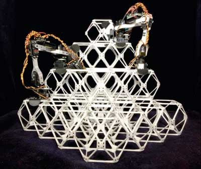 two prototype assembler robots at work putting together a series of small units, known as voxels, into a larger structure