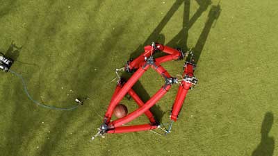 Overhead view of an isoperimetric robot grasping and handling a basketball