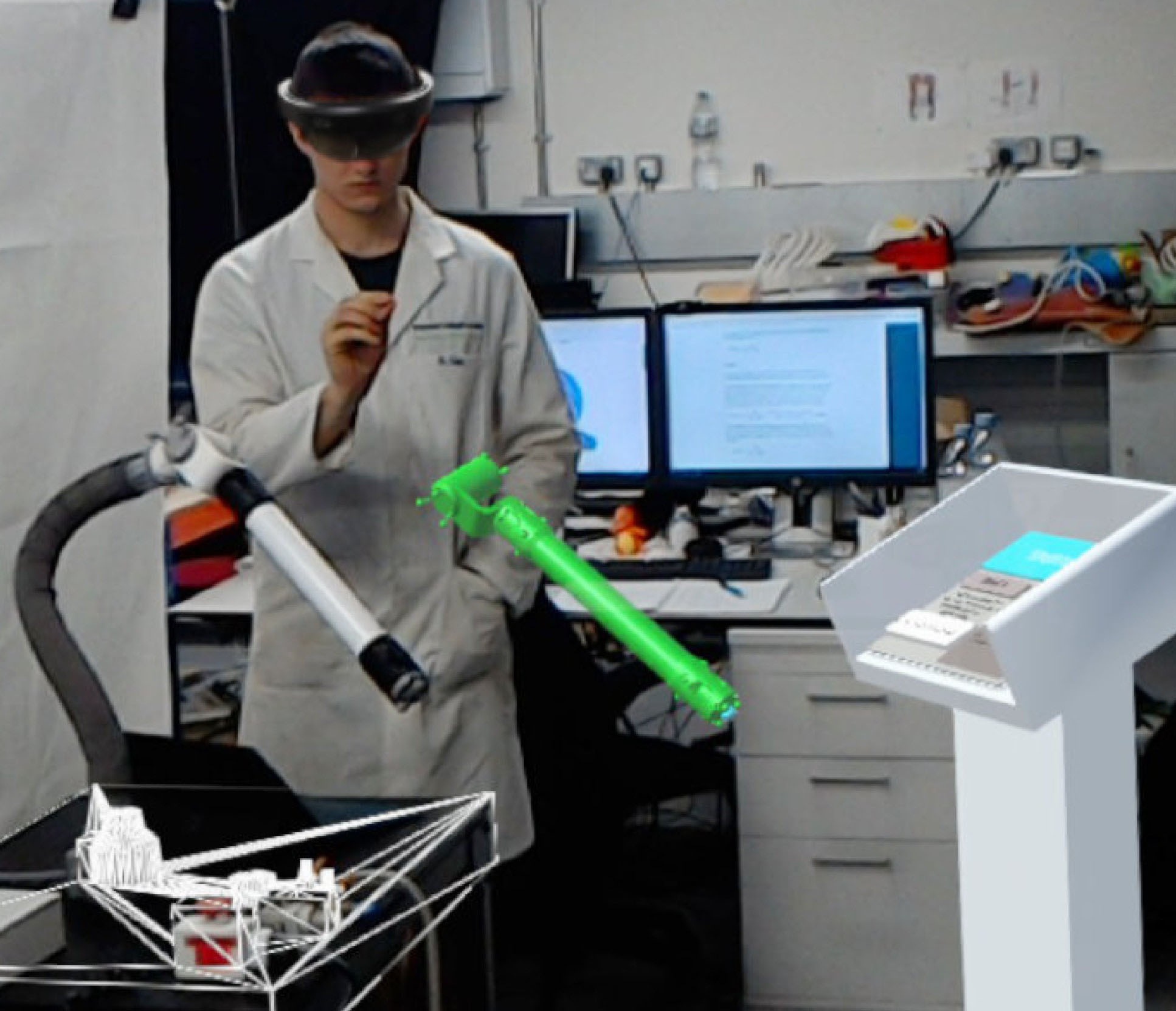 Photo of a researcher configuring the robot using AR. Superimposed onto the photo are the images shown through the goggles: a template turned green, to indicate successful configuration